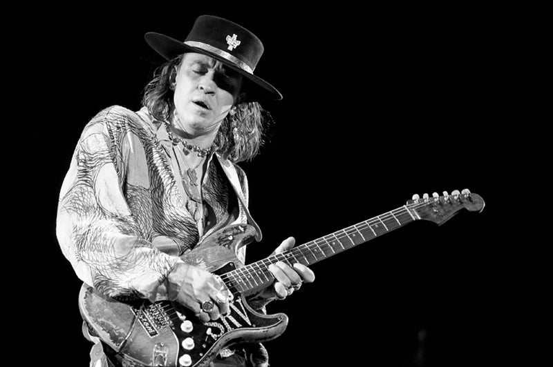 Stevie Ray Vaughan performing live in 1986, photographed by Ebet Roberts, black and white photograph