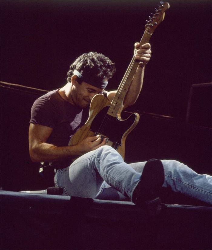 Bruce Springsteen Reclining with Guitar, 1985, photographed by Patrick Harbron.