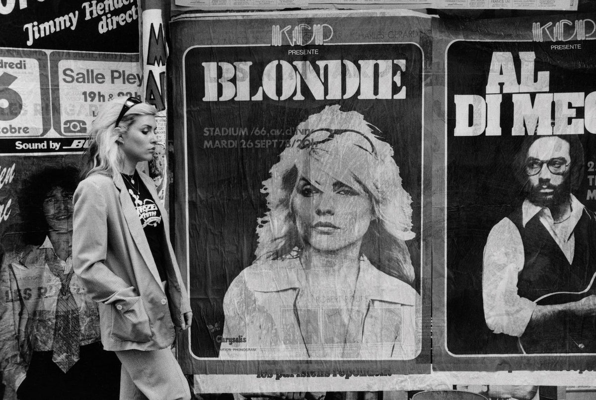 Debbie Harry in front of Blondie concert posters, photographed by Chris Stein in New York City.
