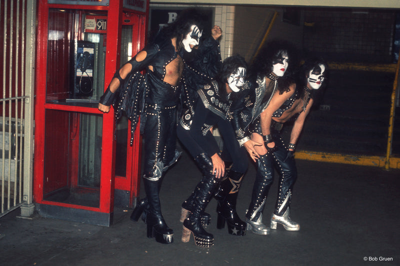 Members of Kiss exiting a phone booth in New York City, 1974, photographed by Bob Gruen.