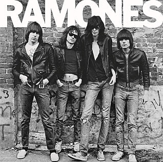 The Ramones posing against a brick wall for their debut album cover, New York City, 1976. Photograph by Roberta Bayley.