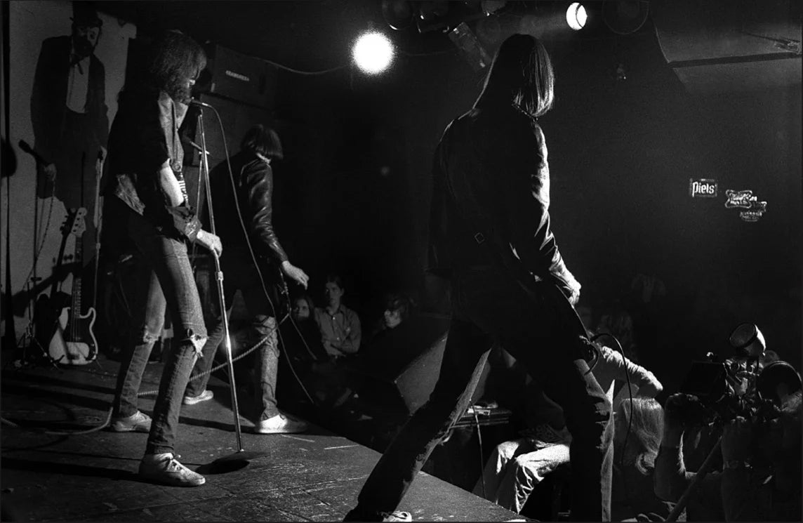Ramones from behind, CBGB, New York City, 1977, photographed by Allan Tannenbaum.